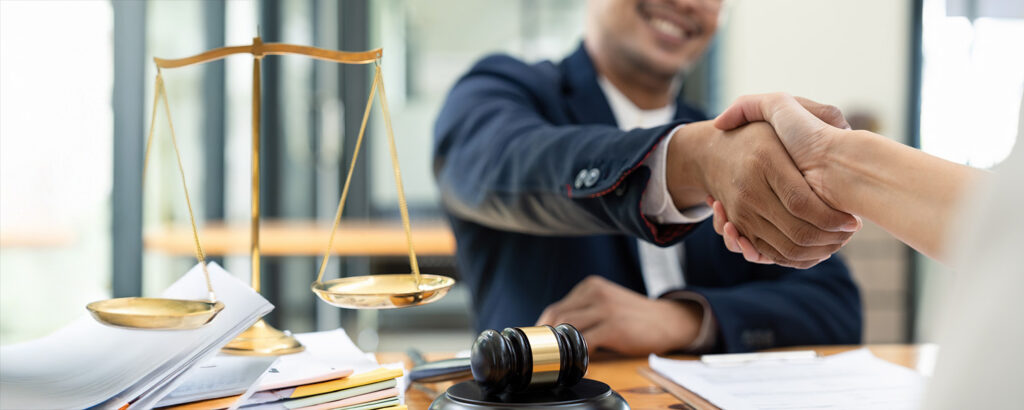 An attorney shakes hands with a client